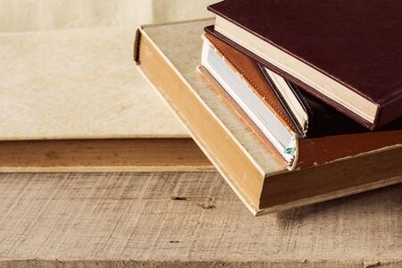 Old books put together on wooden floor.の写真素材
