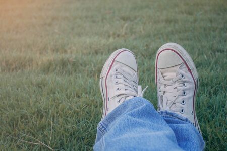 Feet on the grass of people resting with holiday.の写真素材