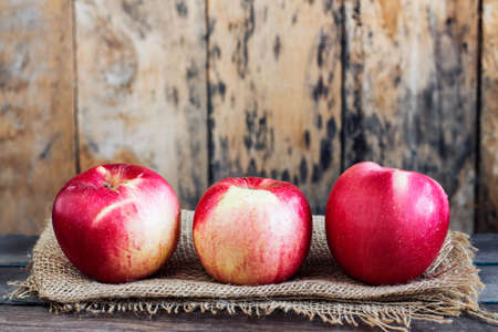 Apples fresh of farm on the old wooden table.の写真素材