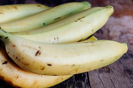 Ripe bananas on old wood with close-up images.の写真素材