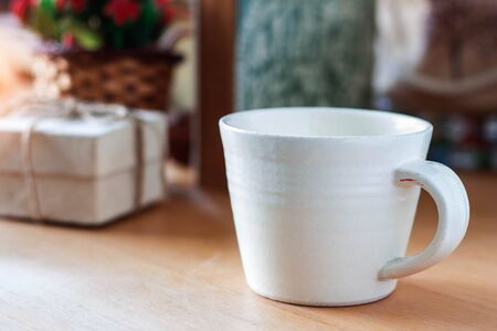 Cup of coffee with a gift on the table.の写真素材