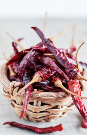 Dried chilli in a bowl with white background.の写真素材