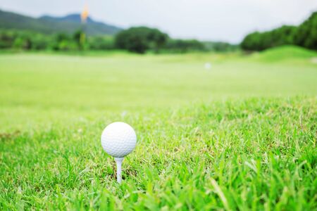 Golf ball on grass with the sky background.の写真素材