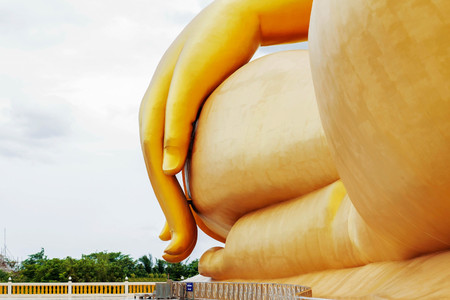 Hand of golden Buddha in temple with the sky.の写真素材