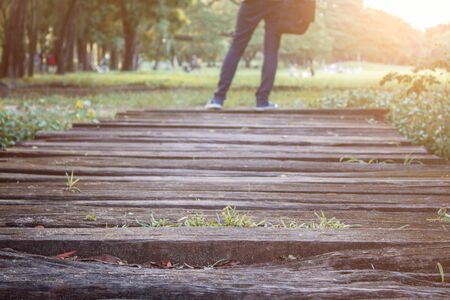 Wood floors of walkways and people in park.の写真素材