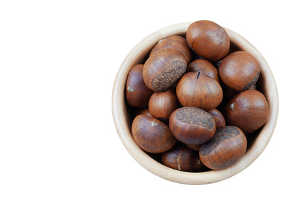 Chestnuts roasted in a bowl on white background.の写真素材