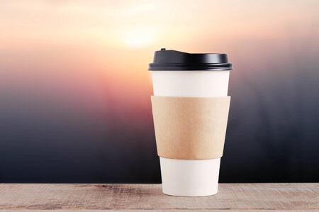 cup of coffee on wooden with the sunrise.の写真素材