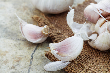 Garlic on cement floor and sackcloth.の写真素材
