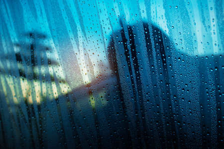Water drops on glass with shadows in the winter.の写真素材