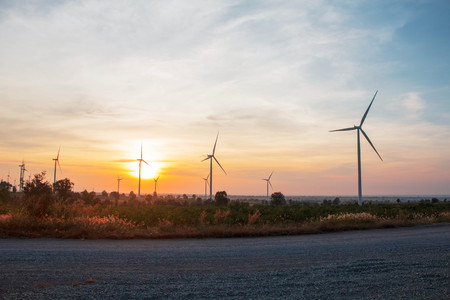 wind farm with sun is rising in the morning.の写真素材