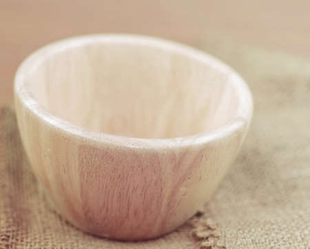 Empty of wooden bowl on a sack.の写真素材