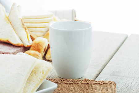 Cup of coffee and bread on the table.の写真素材