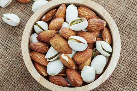 Many almonds in a bowl with close up shots.の写真素材