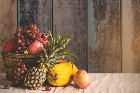 Many fruits in a basket and a white cloth.の写真素材