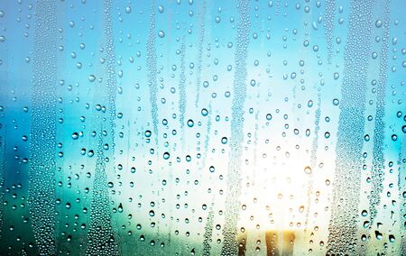 Water drops on glass with the sunlight.の写真素材