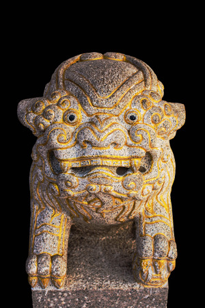 Old lion sculpture on black background.の写真素材