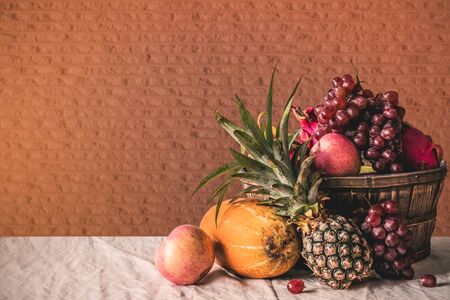 Many fruits in a basket and tablecloth.の写真素材