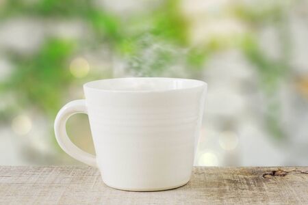 cup of coffee on wooden with a blurred background.の写真素材