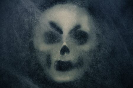 Ghost mask with veil on a black background.