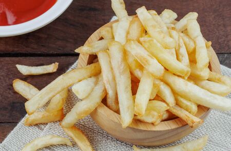 French fries in a bowl on table.の写真素材