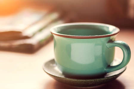 cup of dusty and a newspaper on the desk.の写真素材
