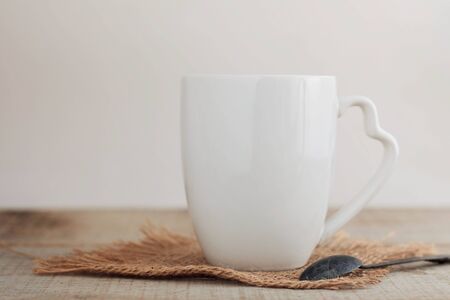 White ceramic cups on old wooden floor.の写真素材