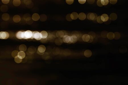 Bokeh golden circle with black background.の写真素材