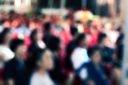 people sitting on chairs with blurred images.の写真素材
