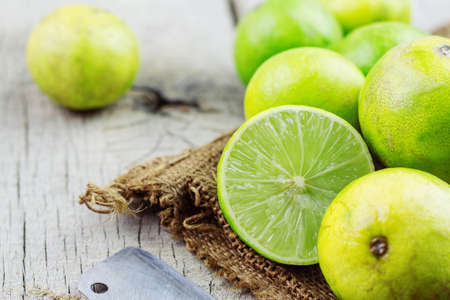 Fresh lime cut of half on a wooden table.