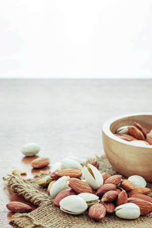 Almonds on sacks and wood floors.の写真素材