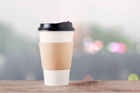 Coffee cup on wooden floor with bokeh background.の写真素材