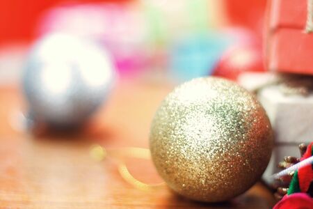 Golden balls and gift boxes on wooden floors.の写真素材