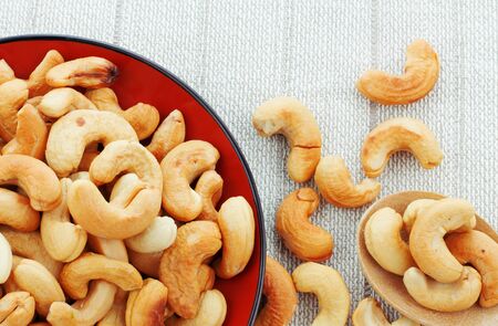 Cashew salt roasted in a plate on tablecloth.の写真素材