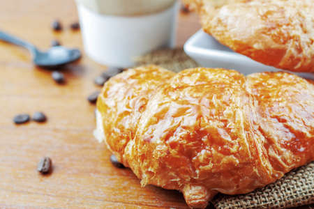 croissants and coffee on wooden floor.の写真素材