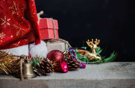 Gift and Christmas decoration on wooden with black background.の写真素材
