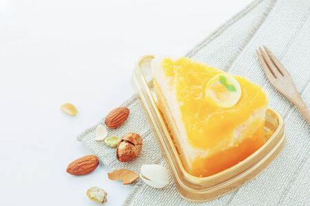 Orange cake and almond on table cloth with a white background.の写真素材