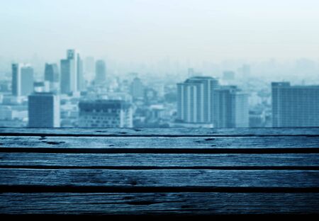 Wooden planks with views of downtown buildings.の写真素材