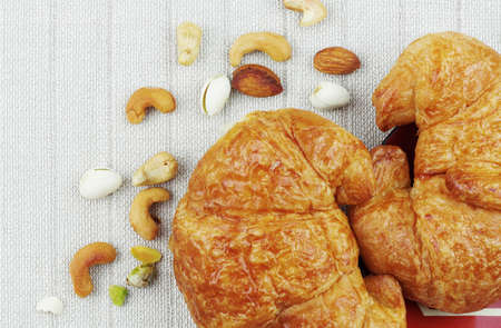 croissants and nuts on table cloths.の写真素材