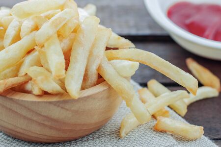 French fries and sauce on wooden floor.の写真素材