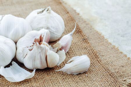 Dry garlic on the old sack in kitchen.の写真素材