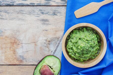 Avocado in a bowl on tablecloth of wood.の写真素材