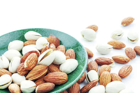 Almond mixed in plate on a white background.の写真素材