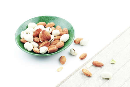 Almond mixed on dish with a white background.の写真素材