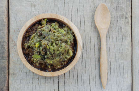 Avocado in a bowl and spoon on wooden floor.の写真素材