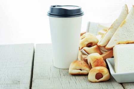 Bread and coffee cup on the wooden table.の写真素材