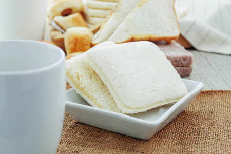Bread and coffee cup on a sack.の写真素材