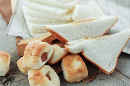 Various breads on a wooden floor.の写真素材