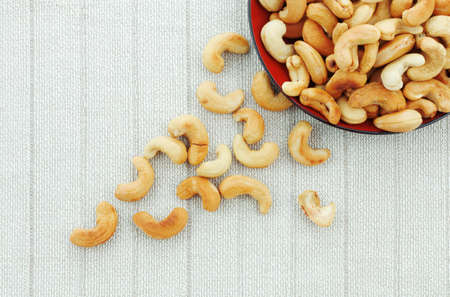 Cashew nuts roasted salt on a dish and tablecloth.の写真素材