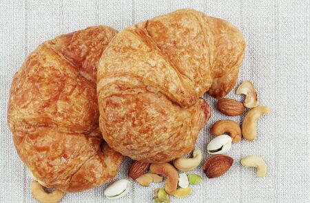 Croissants and many beans on a tablecloths.の写真素材