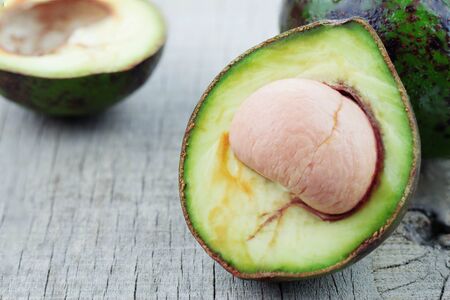 Avocado cuts on the old wooden floor.の写真素材
